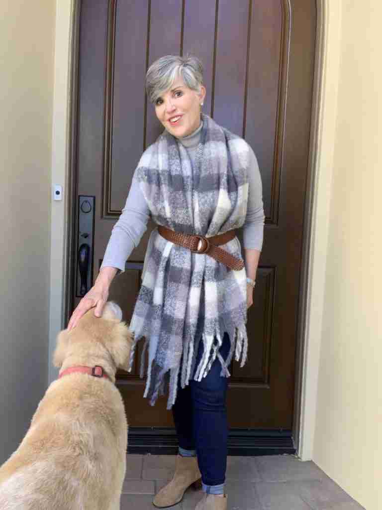 I am wearing a grey turtleneck with a grey and white plaid slubby scarf belted with a brown woven belt over denim jeggings and tan booties.  My golden retriever is in the photo too.