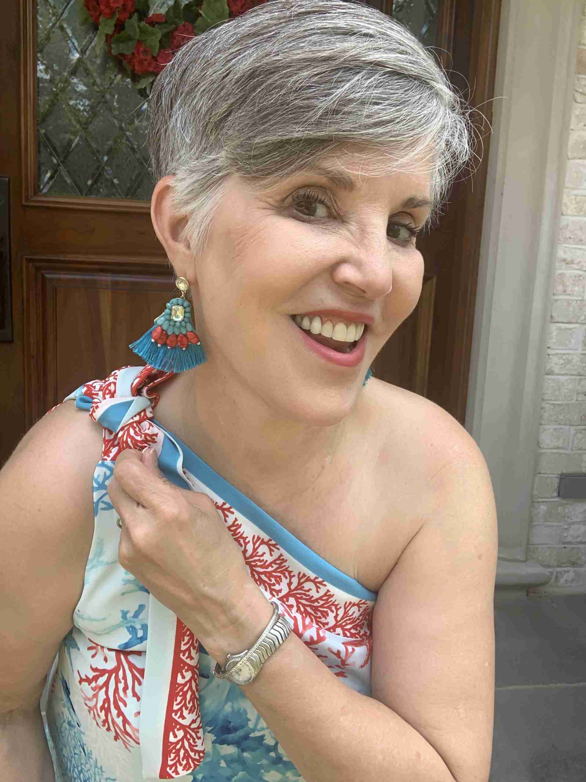 great one shoulder top with coordinating statement earrings, a pretty watch a bracelet