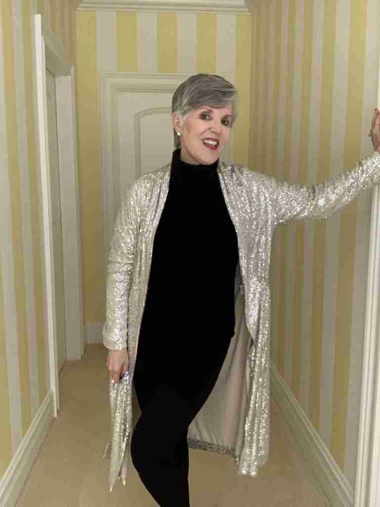I'm wearing a black ribbed turtleneck, black leggings with the glittery duster on top.  An elegant way to wear a glittery holiday outfit.