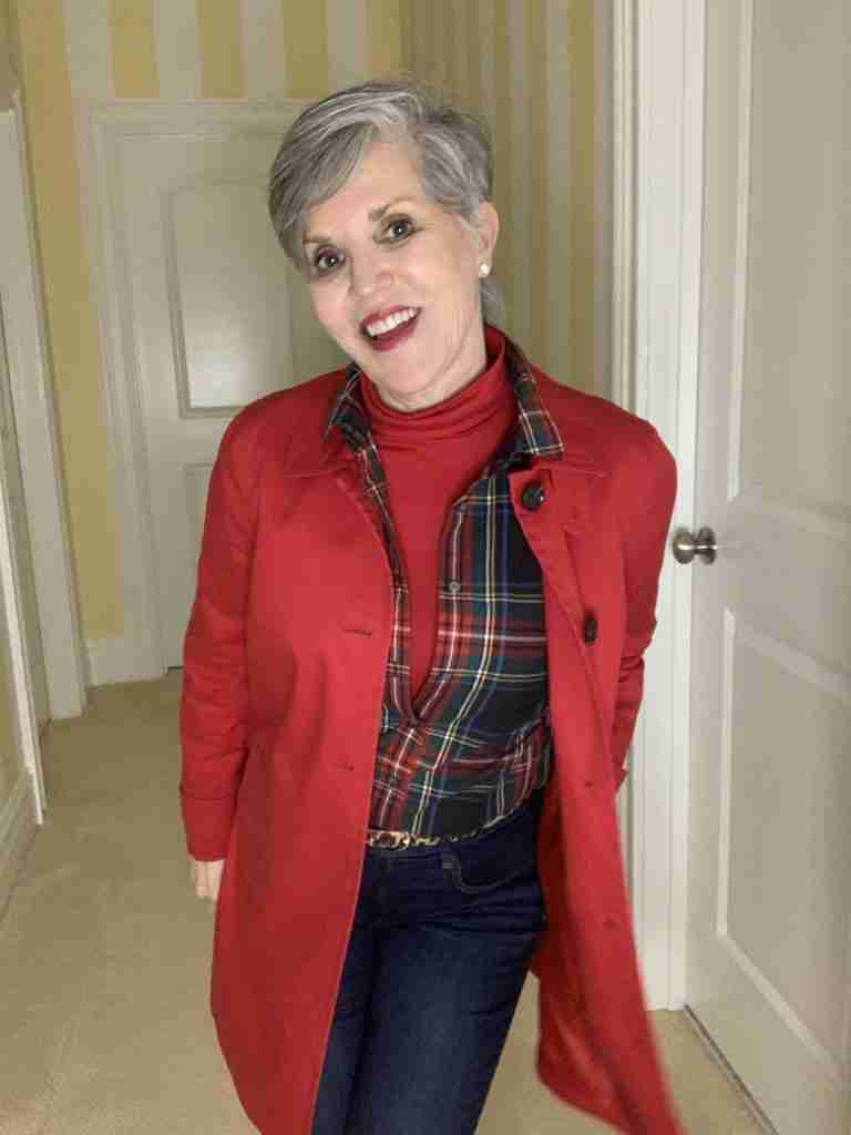red jacket over a plaid shirt with a red turtleneck.  Skinny jeans with a leopard belt.