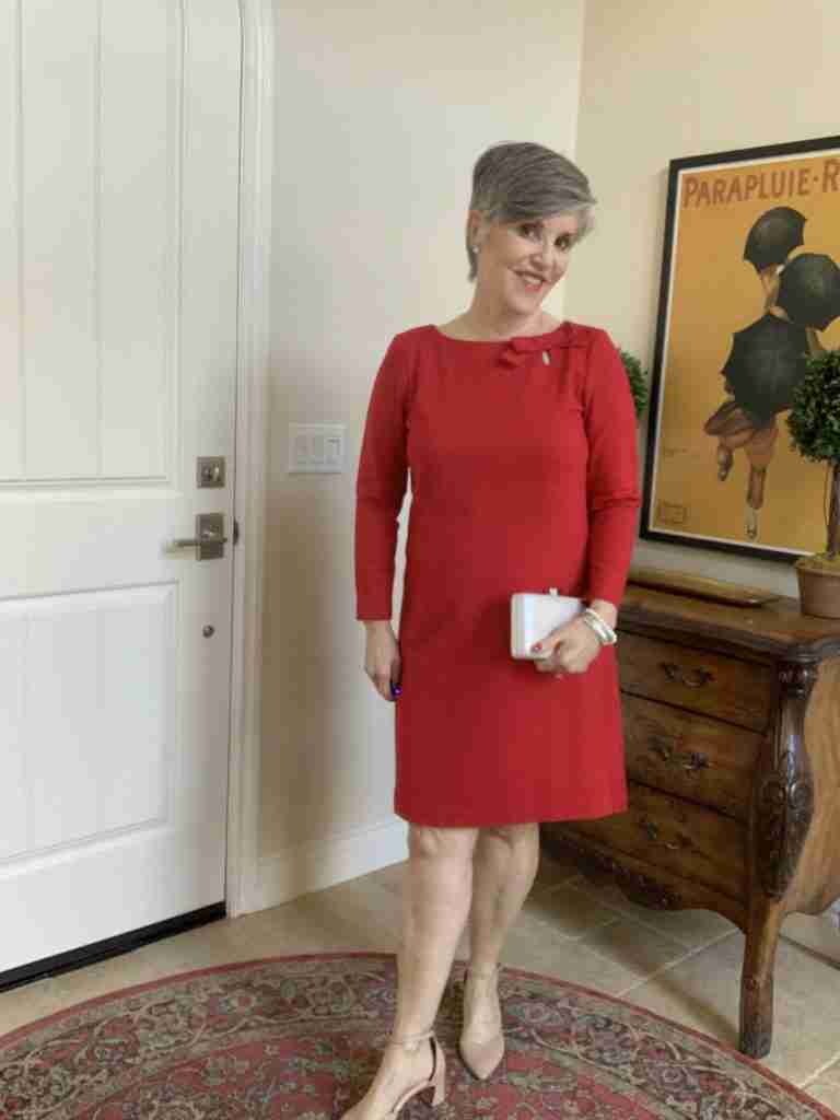 Outfit Number Five (of the Happy Valentine's Day Outfits): Dressy Red Long-sleeve Dress for Valentine's Day.  The dressy long-sleeve red dress has a bow at the neckline and I am wearing the same nude shoes and clutch as the previous red dressy dress.