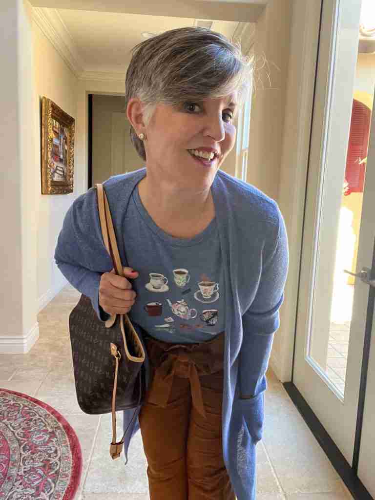 Brown paper bag pants paired with a pretty blue tee shirt that has multiple tea bags and teapots on it. I added a coordinating cardigan and a brown tote with leopard pumps.