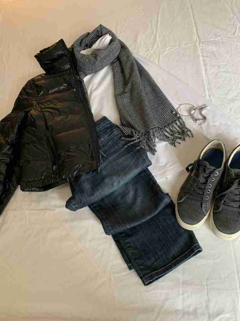 In the flat lay, I took a basic white cotton turtleneck and paired it with boyfriend jeans and the gray gym shoes from outfit number two.  One day I layered on the puffer coat with a black glen plaid scarf, while on the other day, I wore the vest under a coat with a black and gray foulard scarf.