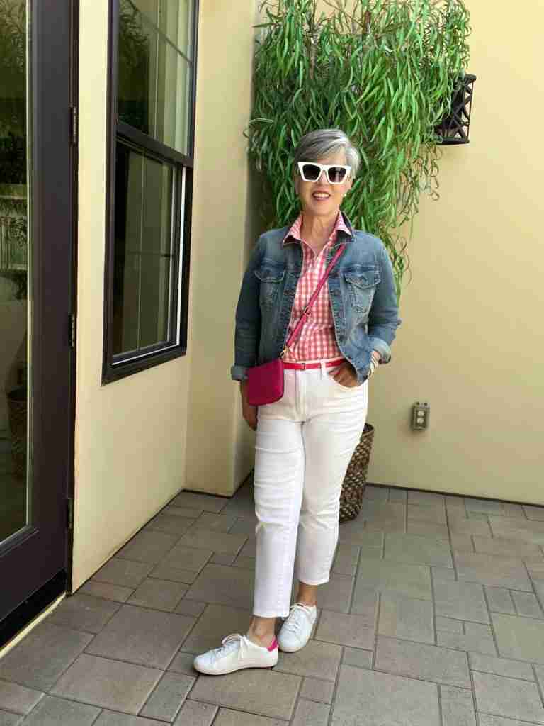 In the fifth and final look, I paired a medium wash jean jacket with the pink gingham shirt, the white pants, and the same white sneakers from above.  I added a small hot pink cross-body bag (that comes in 23 different colors).  Again, I wore the same sunnies, bracelet, and earrings.  I added a hot pink patent leather belt for fun!