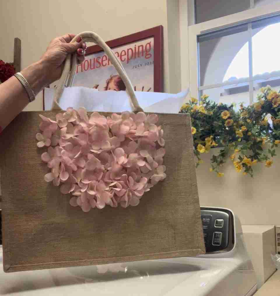 Here's a fun DIY floral tote bag for spring!  It's just about done but since it wasn't fully dry, you can see the sheet of parchment paper peeking out of the top of the bag.
