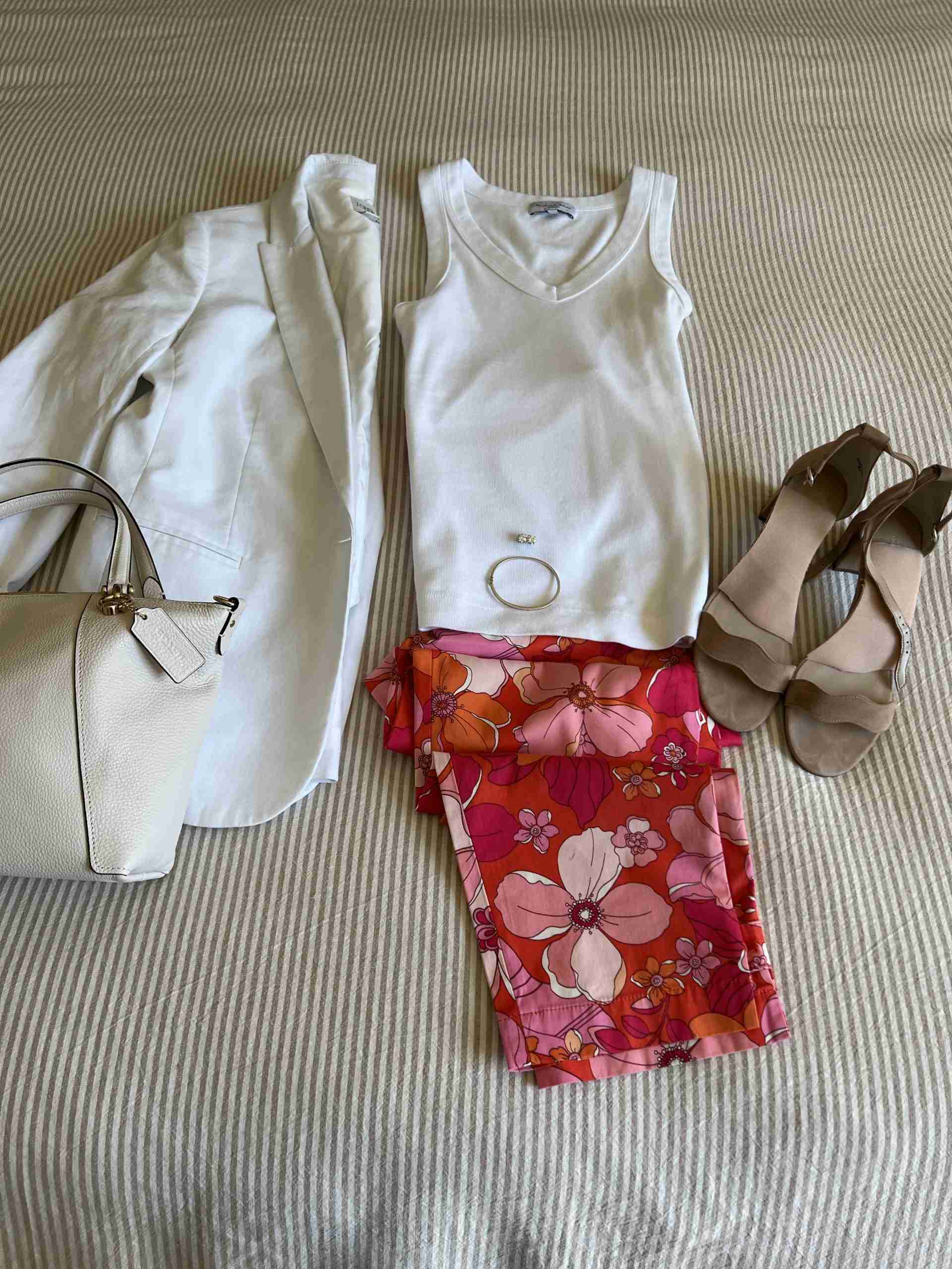 A flat lay of colorful cropped pants with a white linen blazer.  Underneath the blazer is a pretty cotton tank.  My handbag is a sharp white pebbled leather tote and I rolled the sleeves of my jacket.
