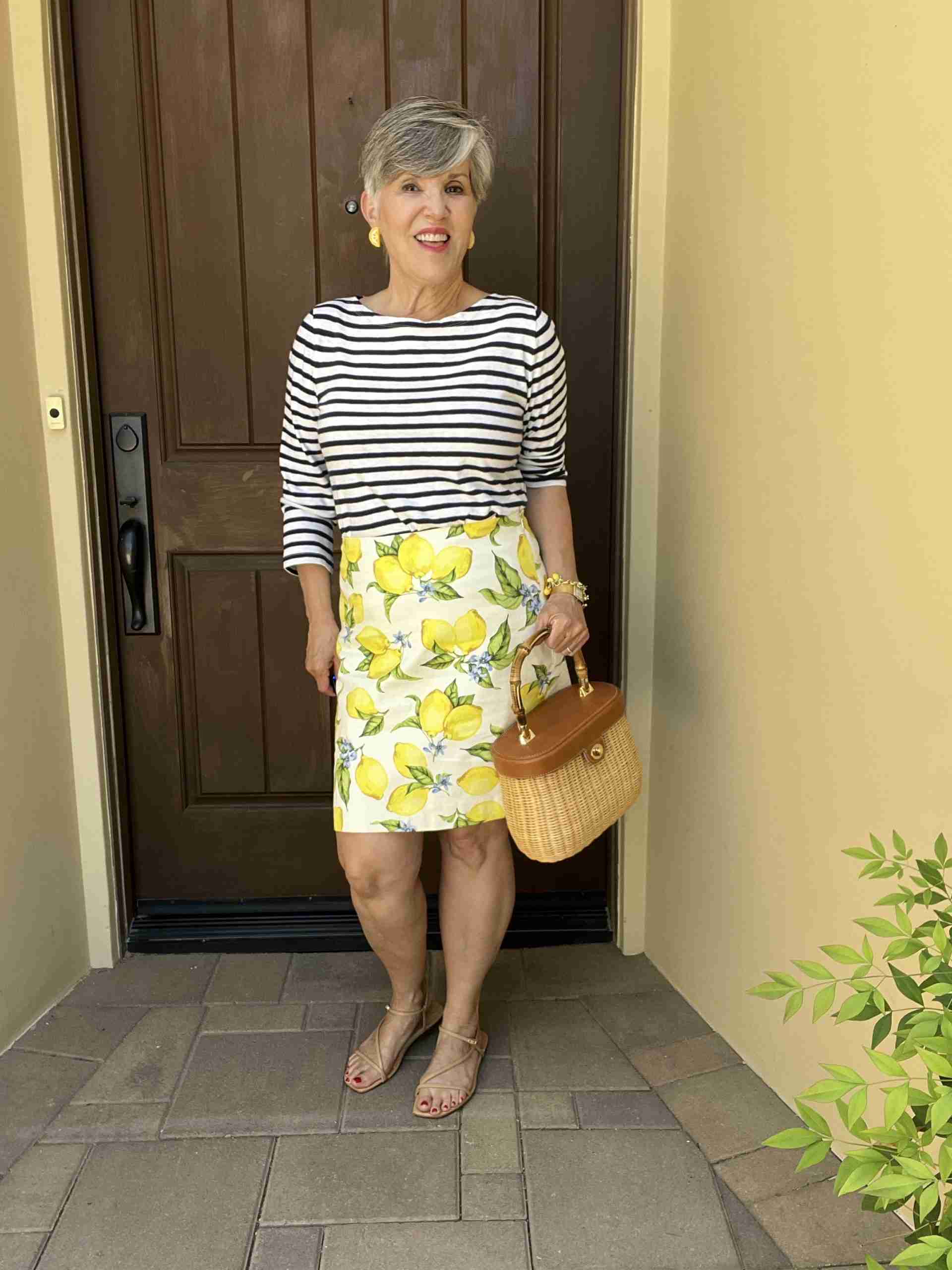 But, I was coming up with lots of lemon print outfits, so this one came to mind.  I wore the striped tee with the lemon print skirt.  I added the lemon earrings and even the lemon charm bracelet.  Is it too much?  Let me know below, please!   To neutralize all the patterns, I added nude flat sandals and a darling classic J McLaughlin wicker and leather purse.