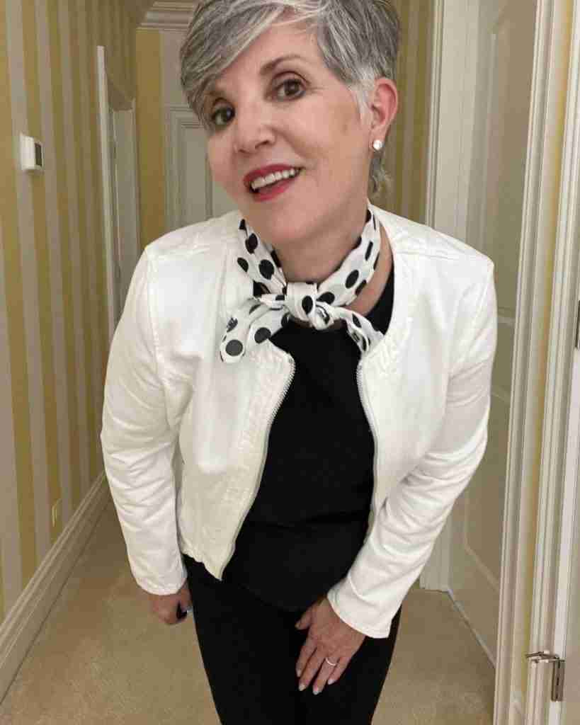 Here is a close-up of my summer travel outfit where I paired the white jean jacket over the black tank and black striped leggings.  For accessories, I added a black polka dot scarf and diamond stud earrings.