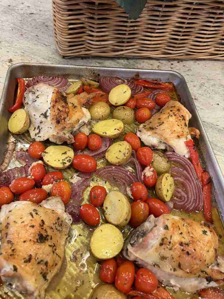 Yummy sheet pan chicken thighs and veggies.  This one pan supper is so delicious and simple to make.  It has fresh herbs and lemons as well as olive oil.