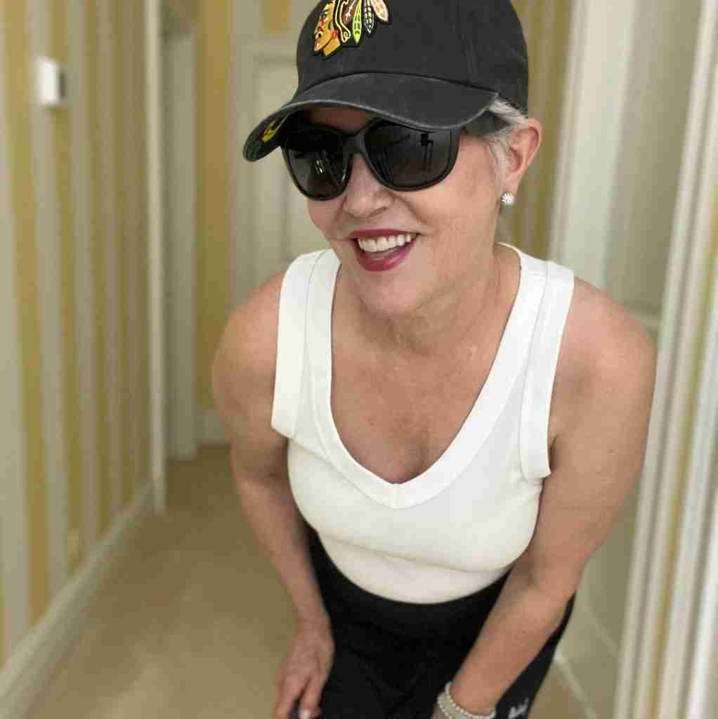 Here is my usual walking outfit: I paired a white cotton tank, black skort, white sneakers with a hat, and sunglasses.