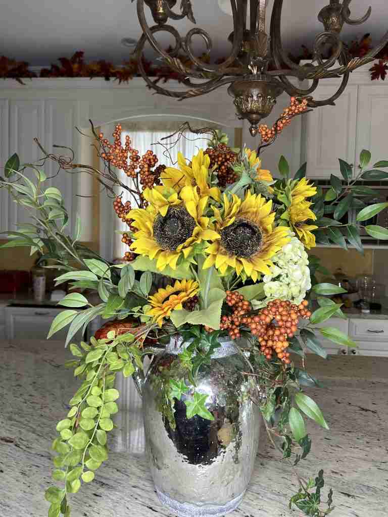 Here is my GORGEOUS DIY 5-minute Fall Sil Flower Arrangement.  It's in a rustic silver pot and consists of six sunflowers, one hydrangea, one Bell of Ireland and some orange berries.