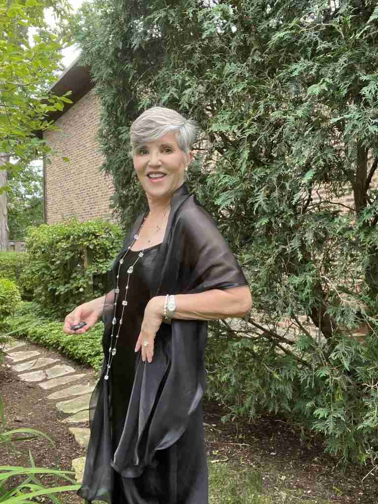  I am wearing the long black silk slip dress as a wedding guest outfit.  I paired it with nude D'orsay pumps, a sheer black pashmina, a long silver and lucite bead necklace from my friend Molly, and diamond stud earrings.  I added a silver bangle and my stainless Ebel watch.