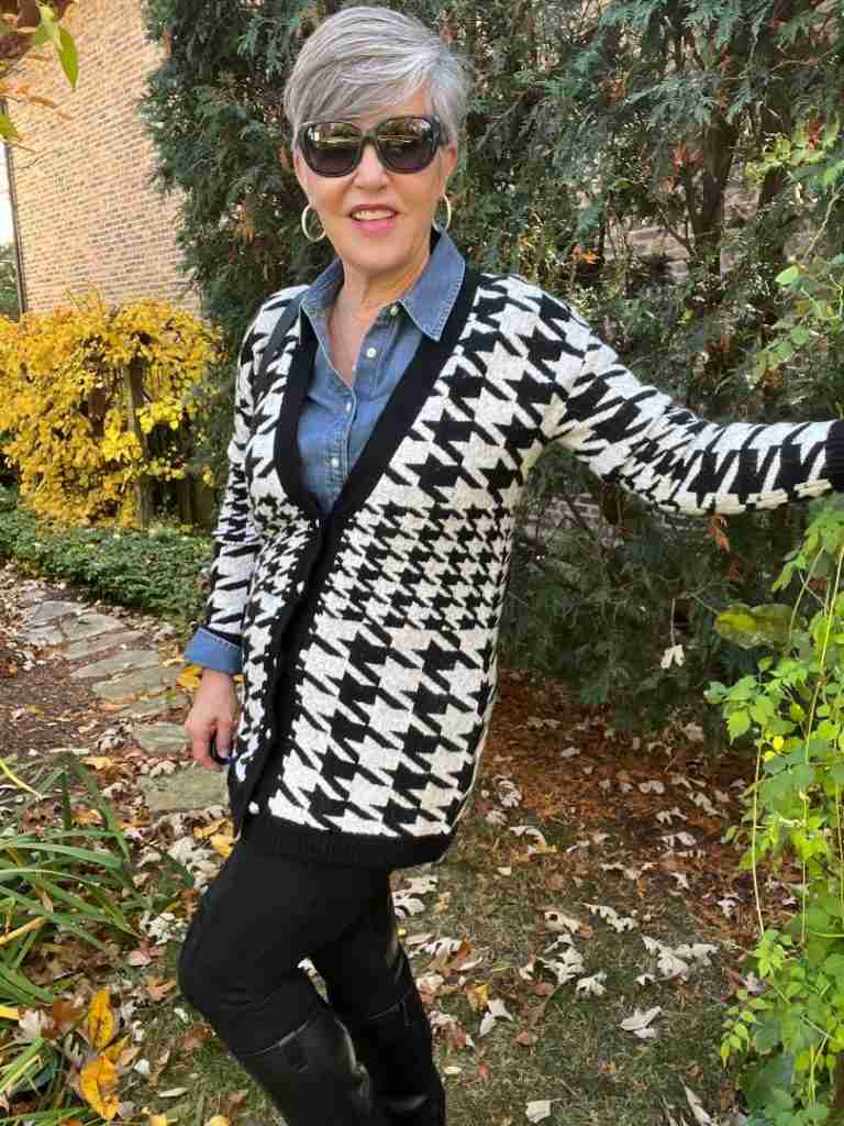Here I am in the houndstooth cardigan with a denim shirt underneath.  I have a black leather backpack as well as silver pave hoop earrings.  My pants are black faux suede leggings and my boots are black leather riding boots.