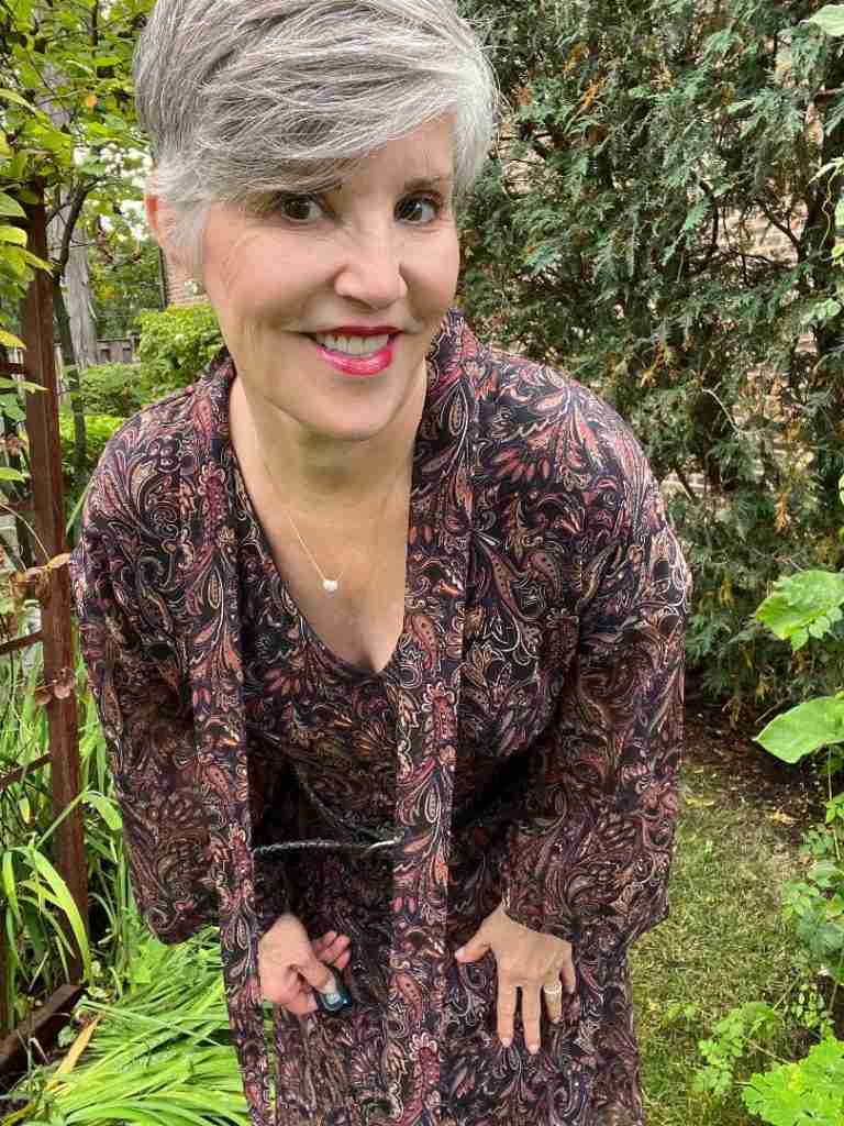 Here is a closeup of the dress outfit. Here is a solution to what to wear for Thanksgiving.  I am spring an Evereve print dress with a pair of tan slouchy suede boot.  For jewelry, I am wearing a pave heart necklace and a stainless steel Ebel watch.