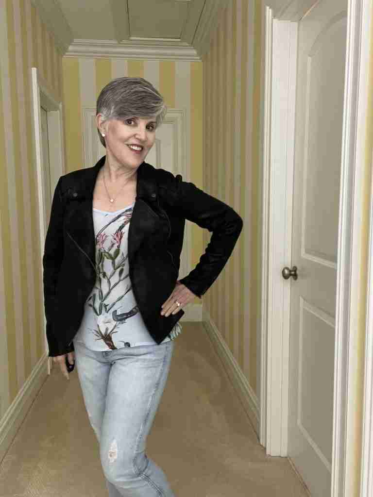 In this third casual date night look I paired a satiny pale blue camisole with a black faux moto jacket and distressed jeans. I added a pave silver heart necklace to fill in the neckline.   I also am wearing diamond stud earrings.