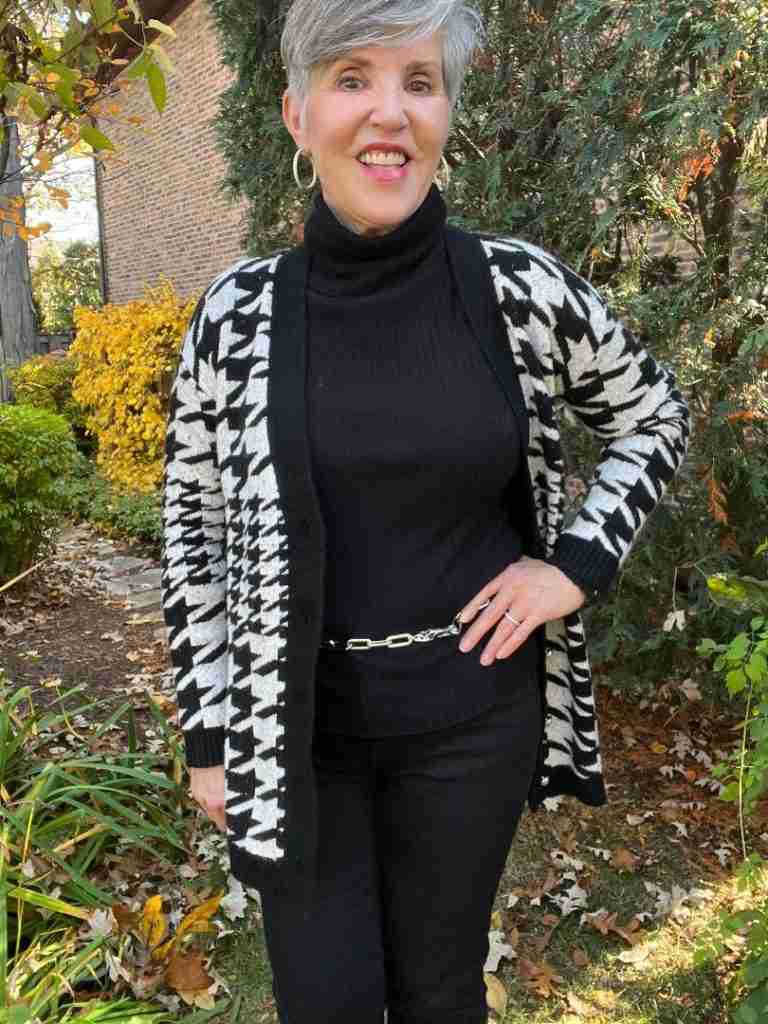 The fifth and final look in my What to Wear for Thanksgiving is a cozy ensemble where again I wore a column of black with a black ribbed turtleneck, black jeans, black suede booties and a classic Talbots black and white houndstooth cardigan.  I added a silver link belt and silver pave hoop earrings.