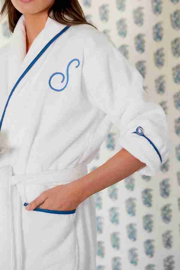 A classic white monogrammed robe with crisp blue piping.