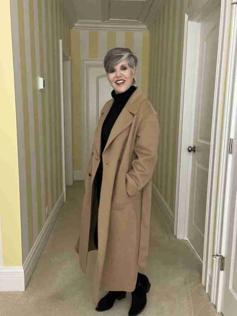 Here is the Gap tan double-faced wool wrap coat with a belt.  It has two rows of horn buttons.  The view is from a 45-degree angle.  I am wearing a black ribbed turtleneck and and black velvet jeans.