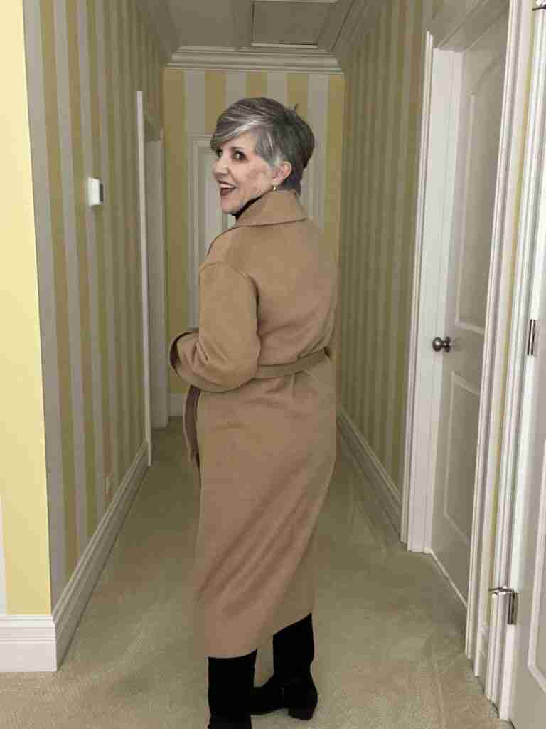 Here is the Gap tan double-faced wool wrap coat with a belt.  It has two rows of horn buttons.  The view is from the rear.  I am wearing a black ribbed turtleneck and and black velvet jeans.