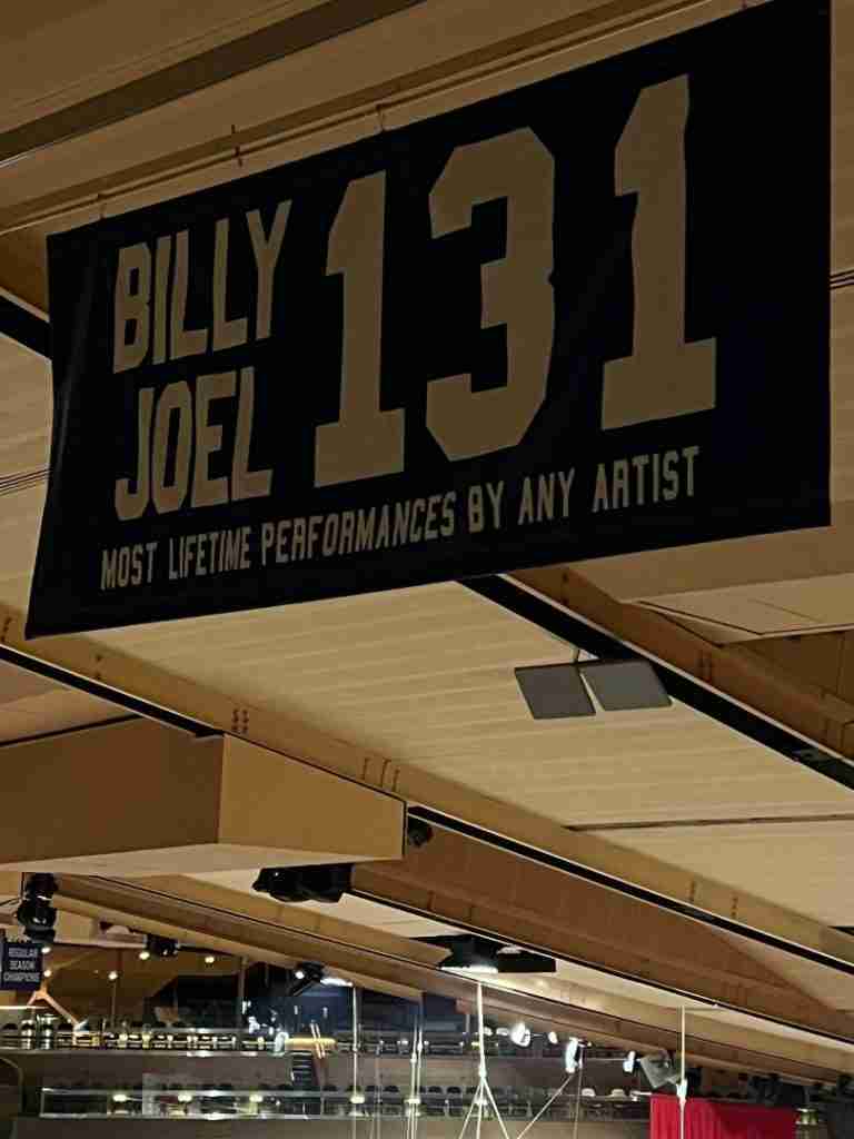 This is a photo of a banner stating that Billy Joel has had the most lifetime performances by any artist.