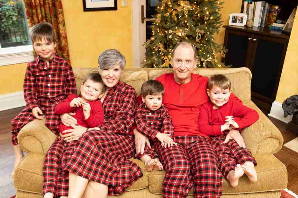 Isn't this a great holiday family photo outfit?  All of us are wearing the same plaid but in various styles.  I ma sitting with Mr. G.Q and our four grandsons on the loveseat in front of the great room Christmas tree.