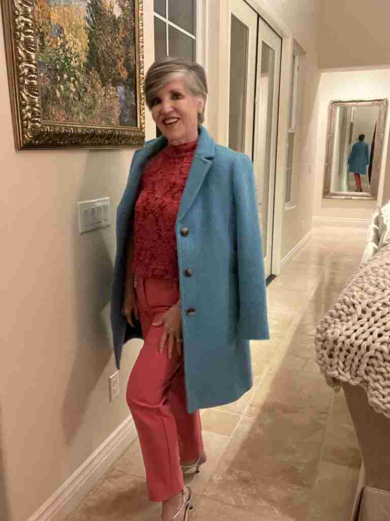 I am wearing a pink damask print halter tops over pink narrow pants and silver sandals.  I am out to dinner with Mr. G.Q. and my friend Irena.  I put a turquoise boucle coat over the outfit.