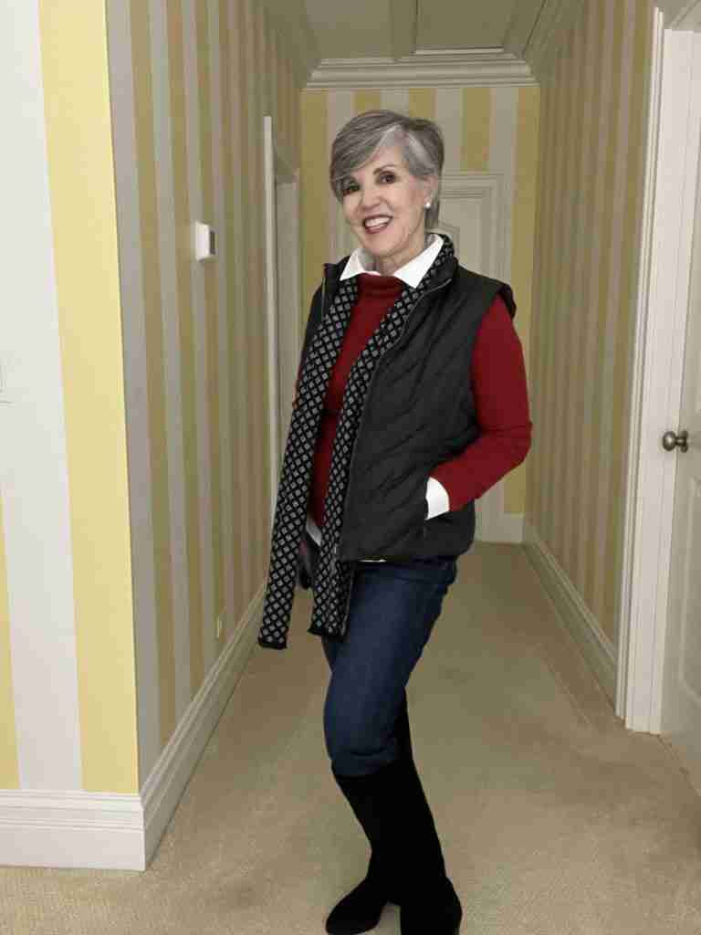 Here is a cozy smart casual winter outfit.  I took a black puffer vest and put it on over a white shirt and a red turtleneck.  My jeans are skinny and they are tucked into black suede high boots.  Lastly, I added a black and white men's scarf.