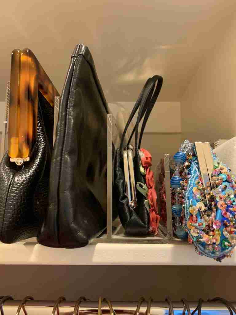 How to Declutter a Closet: Here are some of my purses arranged on a shelf with acrylic dividers separating them.