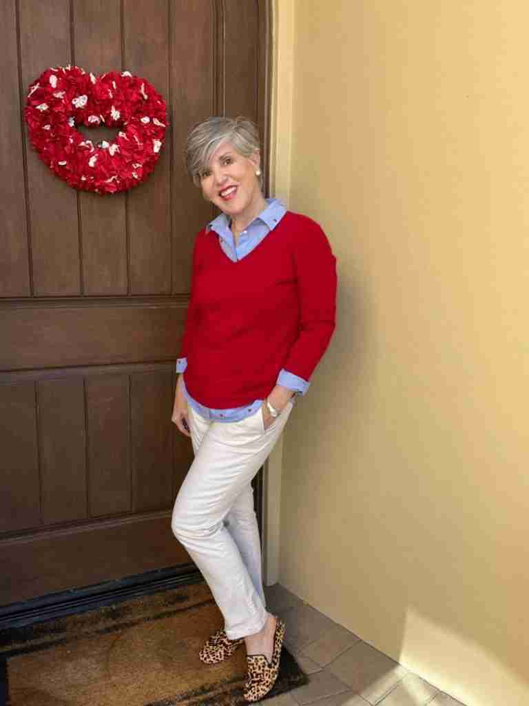 In this first outfit, I paired the Valentine's Day shirt with a red v-neck cashmere sweater.  I left the cuffs and tails peeking out and I added leopard flats.  My pants are tan chinos and it gives the look a casual vibe.  For accessories, I added my classic stainless steel Ebel watch and some pearl stud earrings.