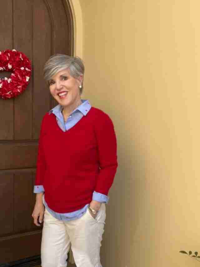 In this first outfit, I paired the Valentine's Day shirt with a red v-neck cashmere sweater.  I left the cuffs and tails peeking out and I added leopard flats.  My pants are tan chinos and it gives the look a casual vibe.  For accessories, I added my classic stainless steel Ebel watch and some pearl stud earrings.