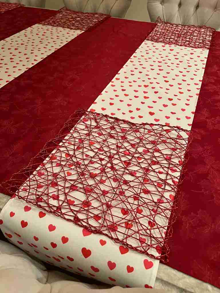 I've now layered a red metallic net-like placemat over the runner.