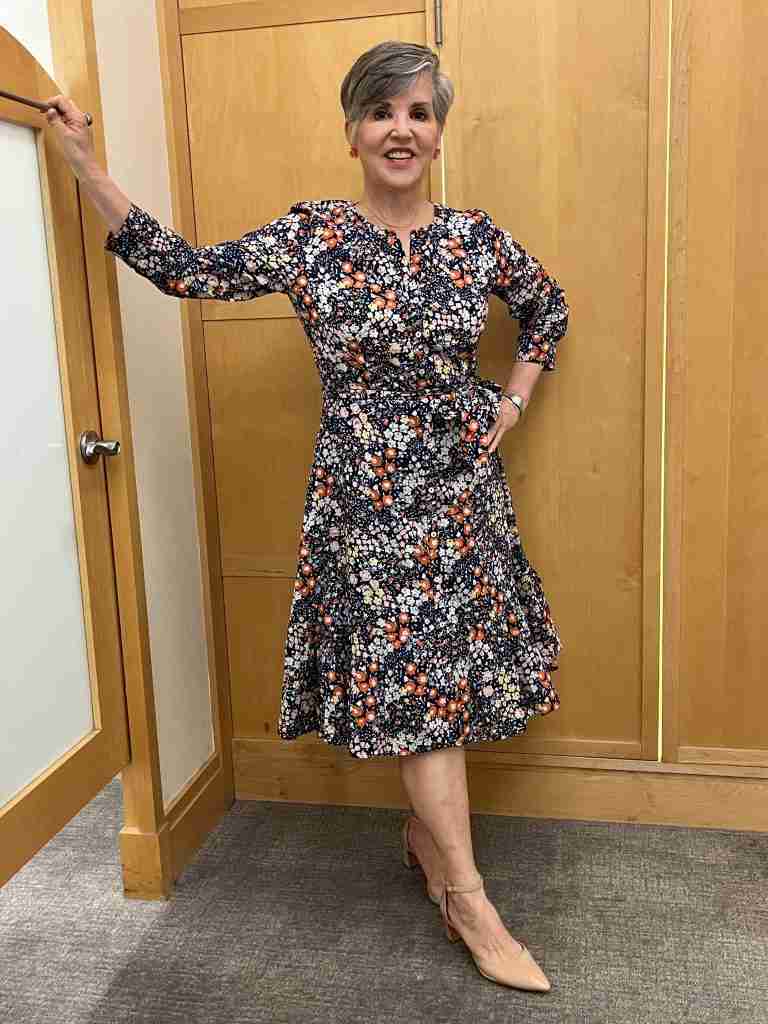Beautiful blue floral midi length dress for spring 2023.  Perfect for a bridal shower outfit or wedding guest look.  Shirt dress style with three-quarter length sleeves.