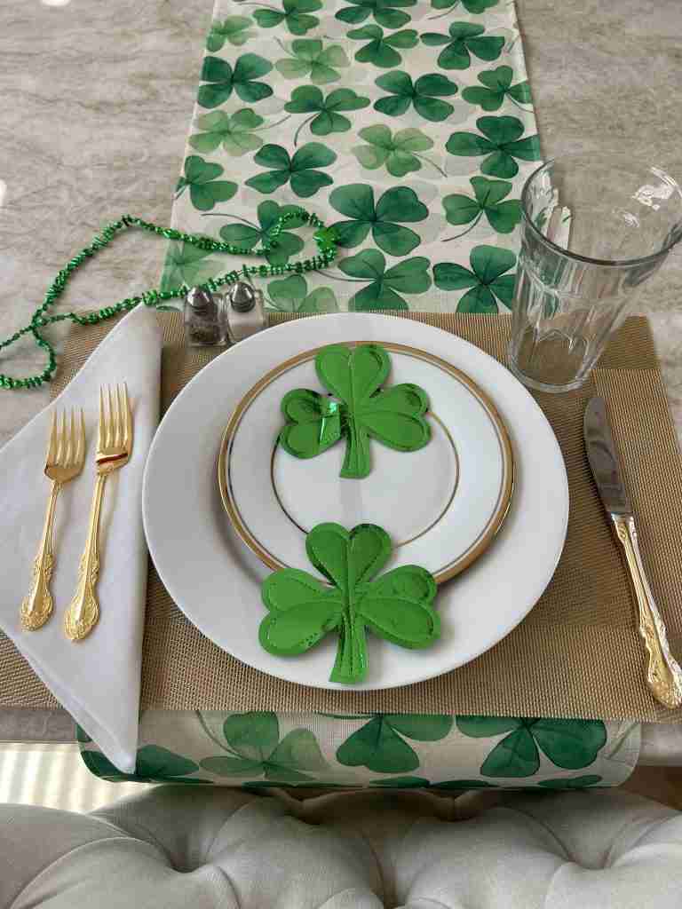 Here is a close-up of the St. Patrick's day table decorations with some shiny shamrocks on the center of the place setting.  I used gold placemats and flatware with white napkins all on the shamrock runner.