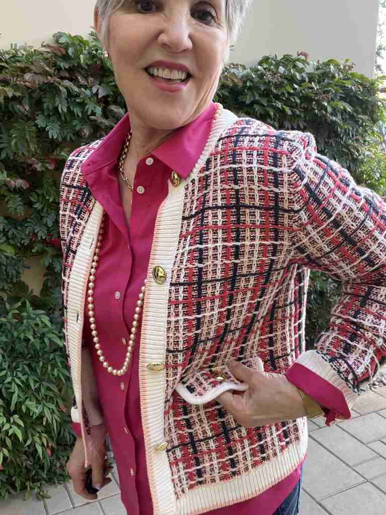 What to wear with a tweed jacket. Here I am in this plaid tweed jacket with a magenta pink shirt under it as well as medium-wash straight-leg jeans.  I'm wearing a pearl necklace and nude pumps for this very ladylike look.  Her is a close-up of the brass buttons on the jacket as well as the gold necklace and pearls.