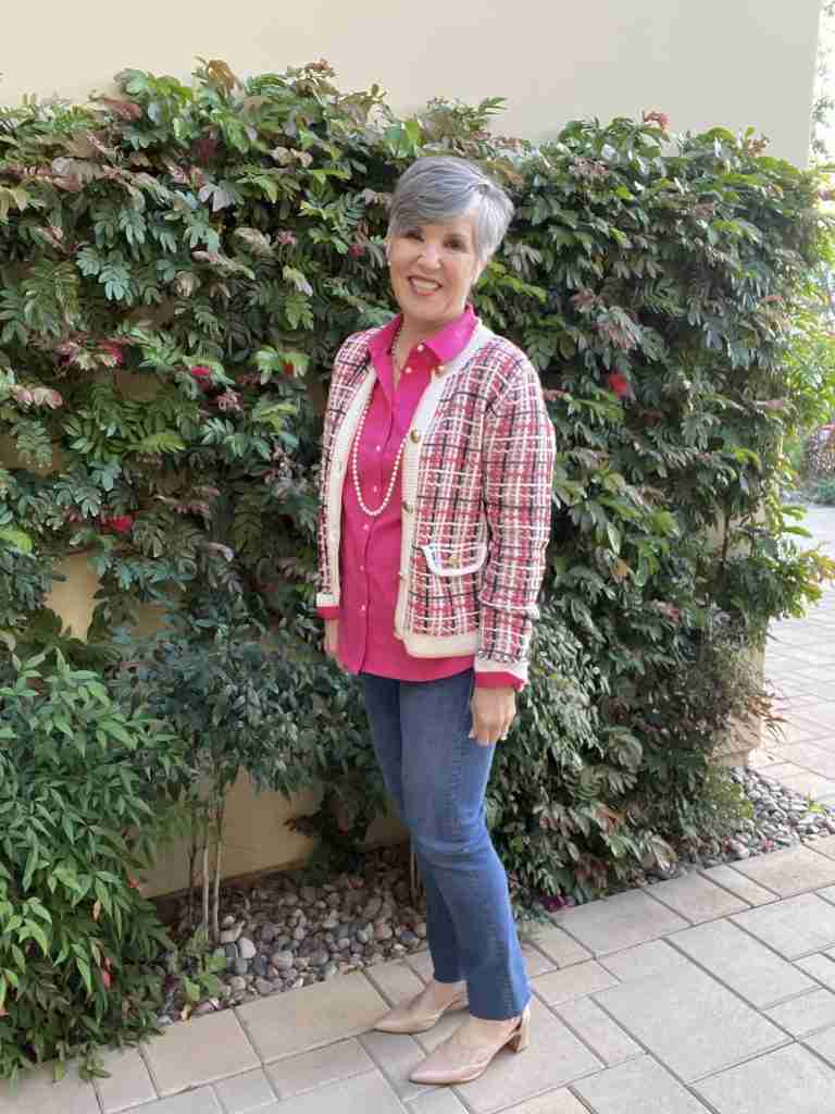 What to wear with a tweed jacket. Here I am in this plaid tweed jacket with a magenta pink shirt under it as well as medium-wash straight-leg jeans.  I'm wearing a pearl necklace and nude pumps for this very ladylike look.