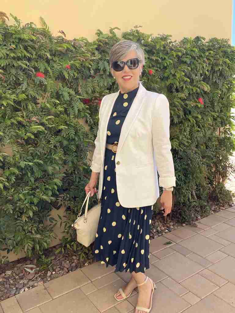 In this last outfit, I am wearing the navy polka dot dress with a white linen blazer.  I have a white Coach satchel handbag.