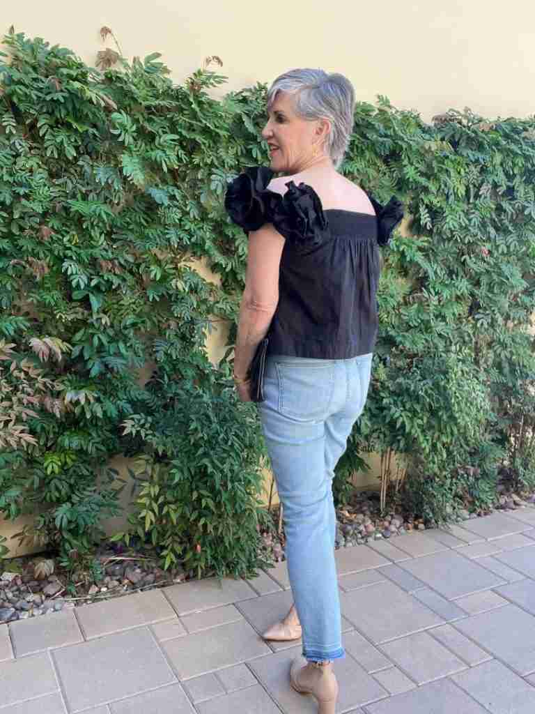 Here is the same black ruffled top but a view from the back.  The back has gentle shirring.  I wore gold hoop earrings and a black clutch.