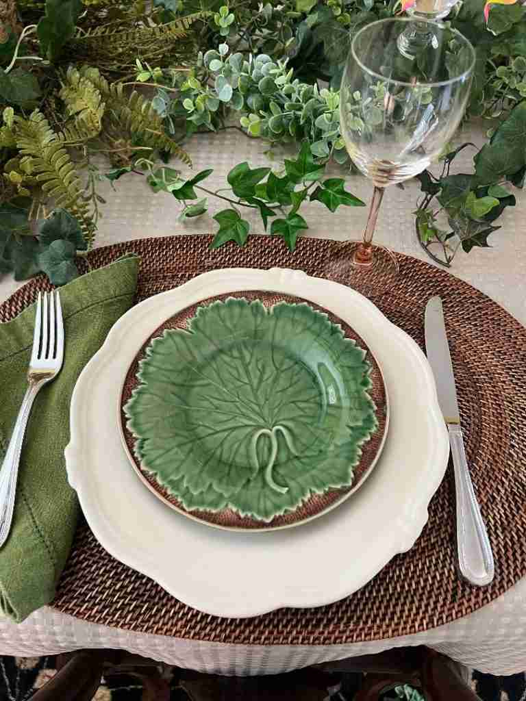 Above, is a close-up of one of the completed place settings after I placed a green lettuce leaf salad plate on top of the cream dinner plate.  That ties together more of the greenery and olive napkins.  Pro-tip: By using the different shades of green in the ivy, the wreath, garlands, napkins, and dessert plates, more depth is created in the Mother's Day tablescape.