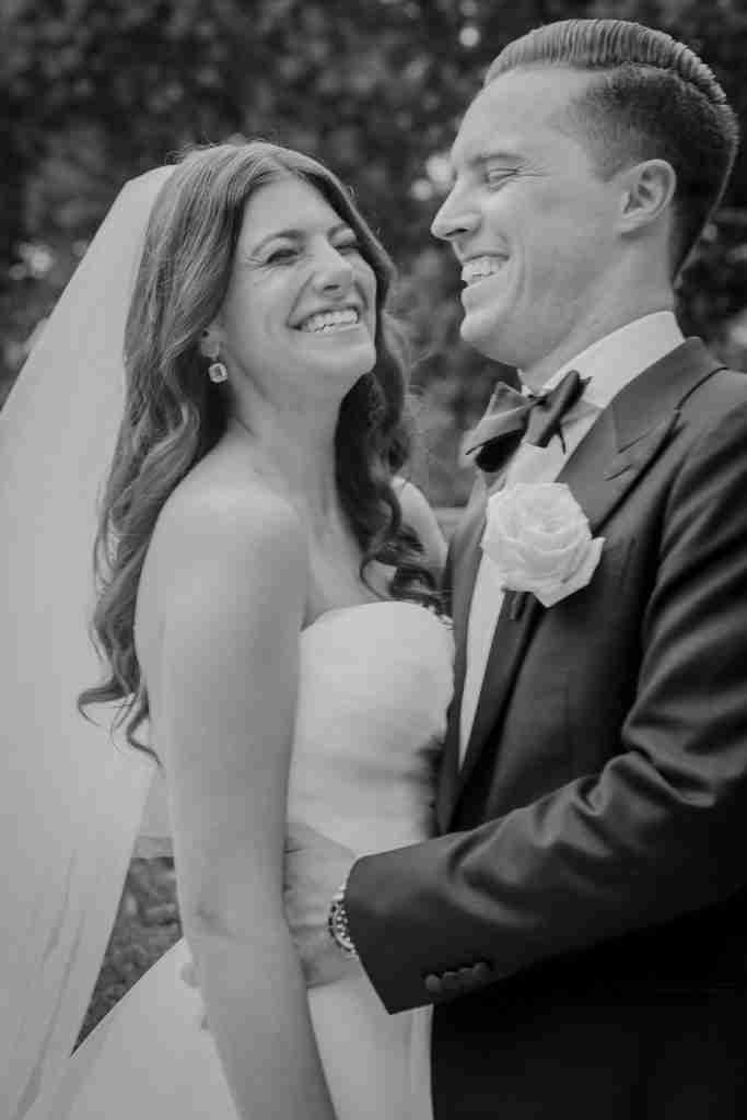 Here is a picture of my son, Jake, and his wonderful new wife, Rachel.  It is a black and white photo and they are both laughing.  She is wearing a gorgeous strapless white dress with a long trailing veil.