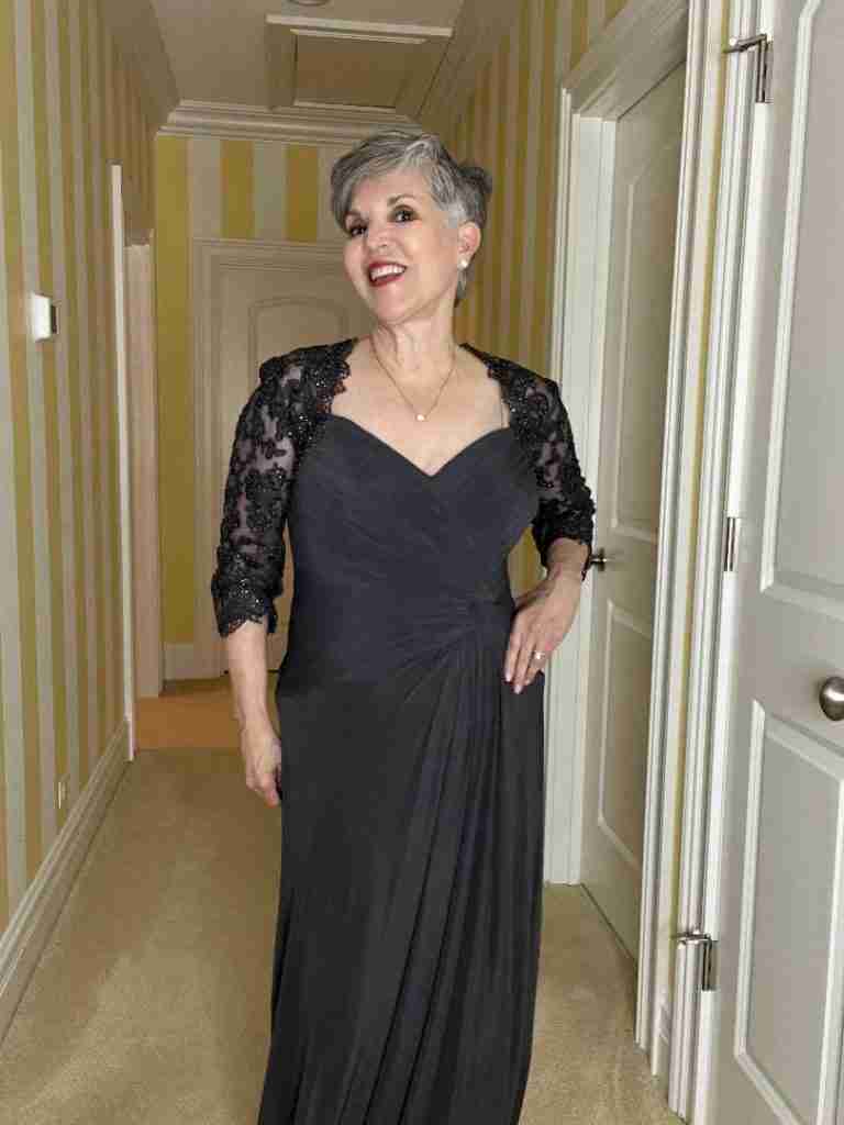 I am wearing a gorgeous gunmetal grey dress with a ruched and knotted waistline.  The shoulders are see-through lace with a bit of sequins.  The neckline is a sweetheart one.