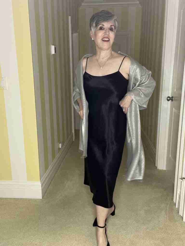 I am wearing a black satin slip dress with black D'orsay pumps and a silver pashmina.  This is a dressy and elegant way to wear a slip dress.