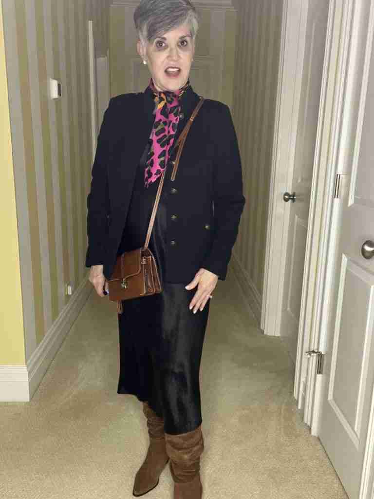 I am wearing the black satin slip dress with a black military jacket, brown scrunched suede boots, a brown cross-body bag and a colorful pink, brown and black leopard scarf.