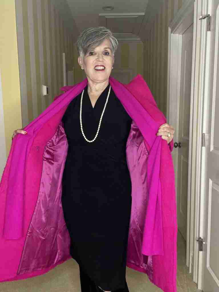 I am wearing the fuchsia classic coat over a black knit Norma Kamali faux wrap dress.  I added a long strand of pearls and diamond stud earrings to complete the classic look.  The coat is opened to see the dress.